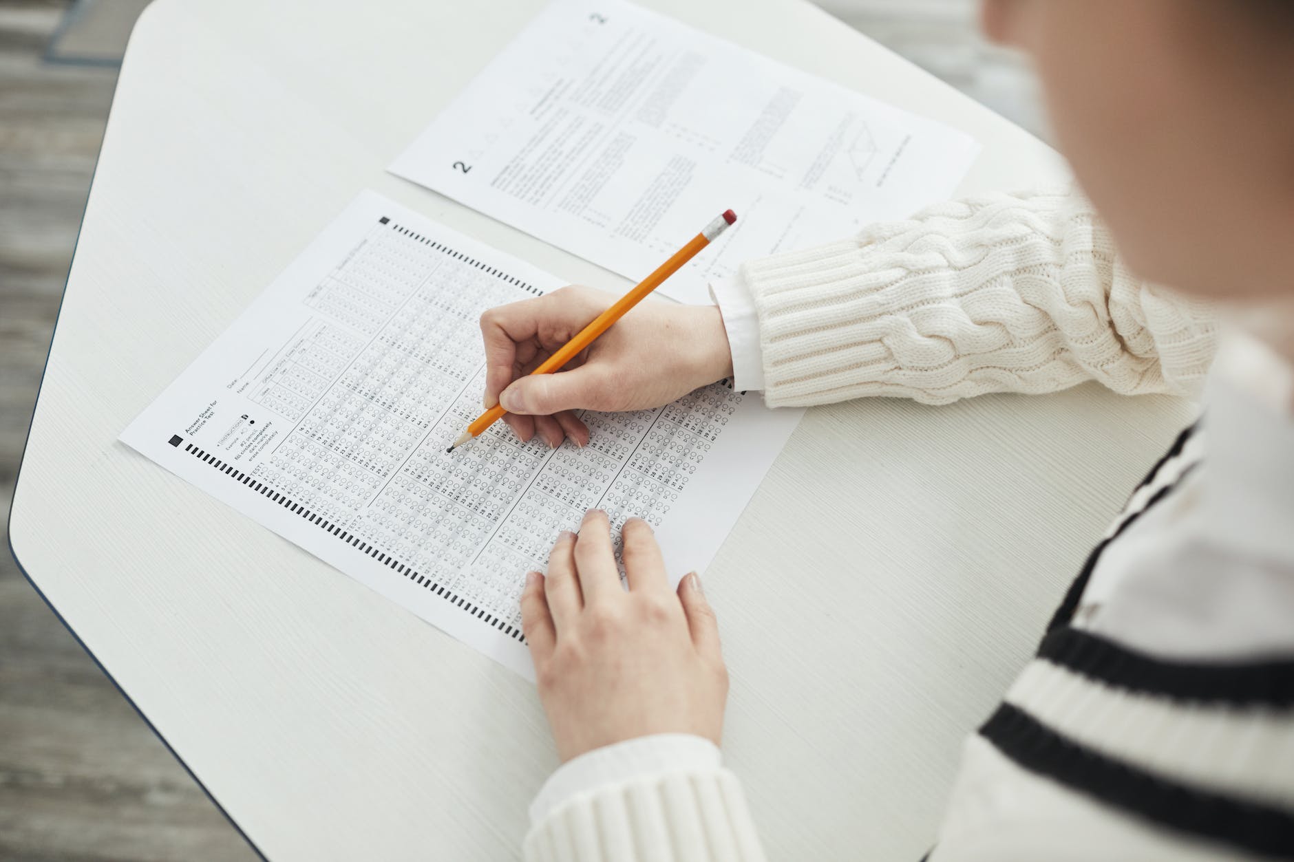 A person taking an exam that goes well after working with a tutor