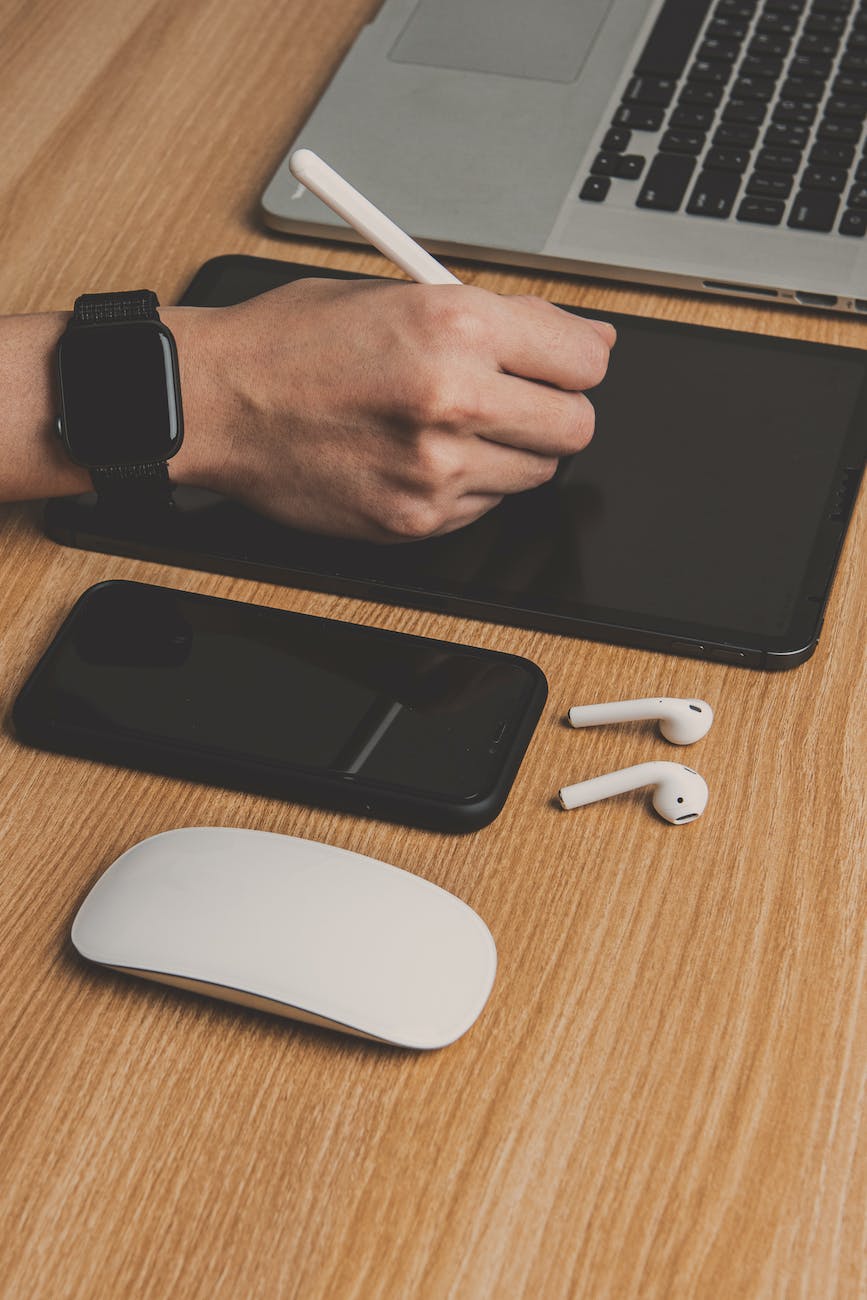 faceless person with graphics tablet near modern multimedia devices